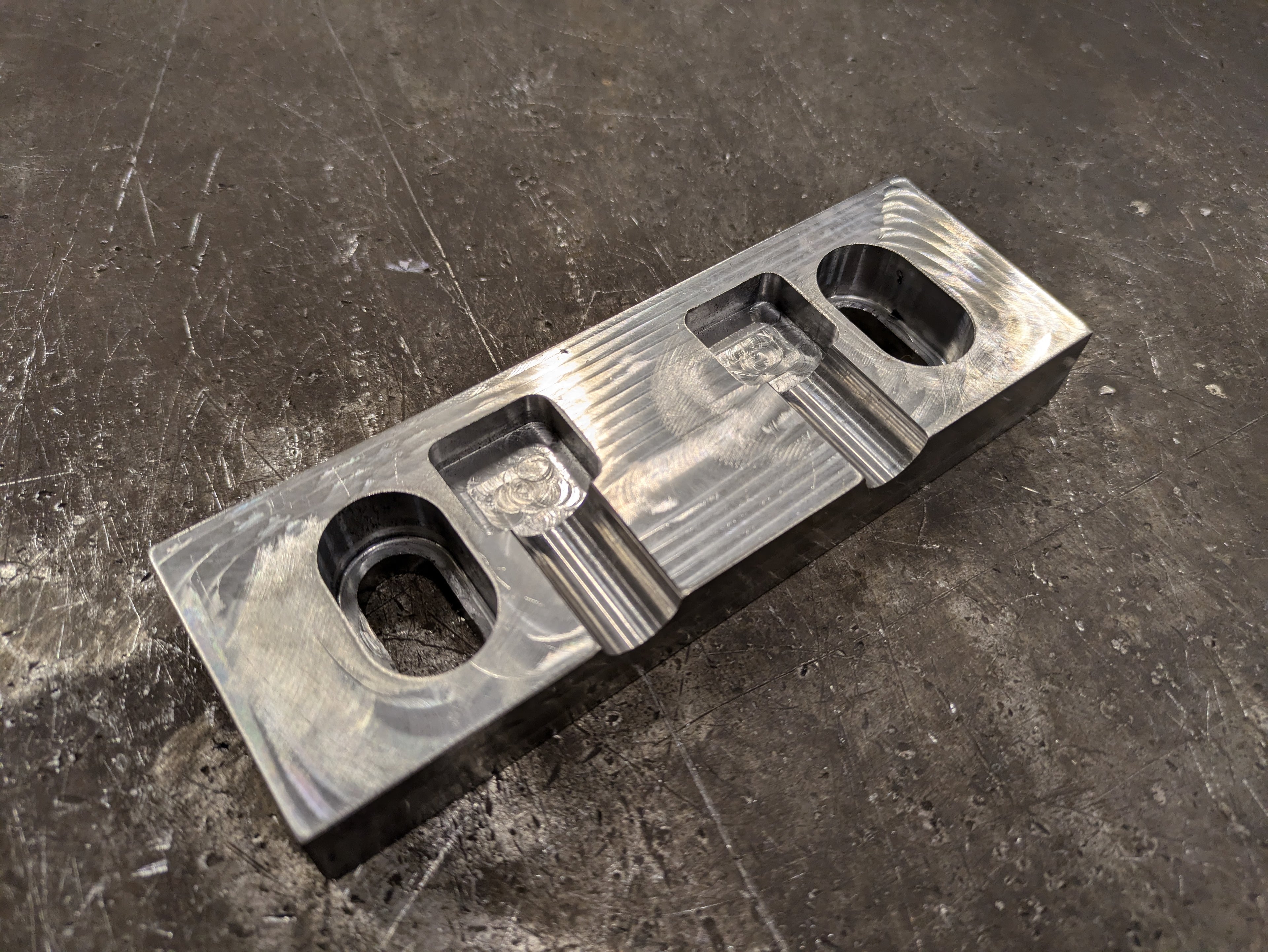 Soft jaw made of 4140 steel, designed to hold a 14mm round rod vertically.