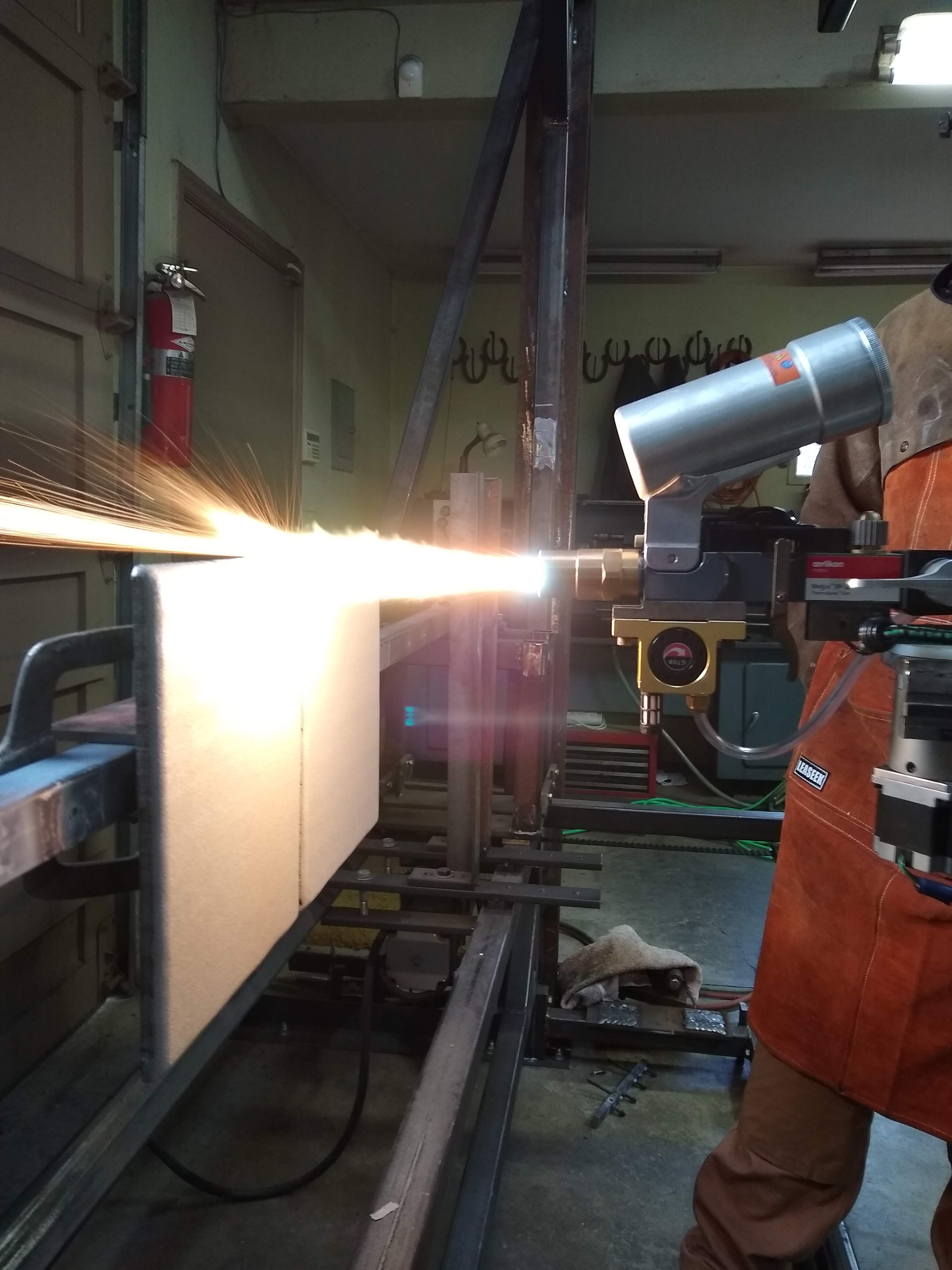 Image of the process of thermally spraying steel wear plates.