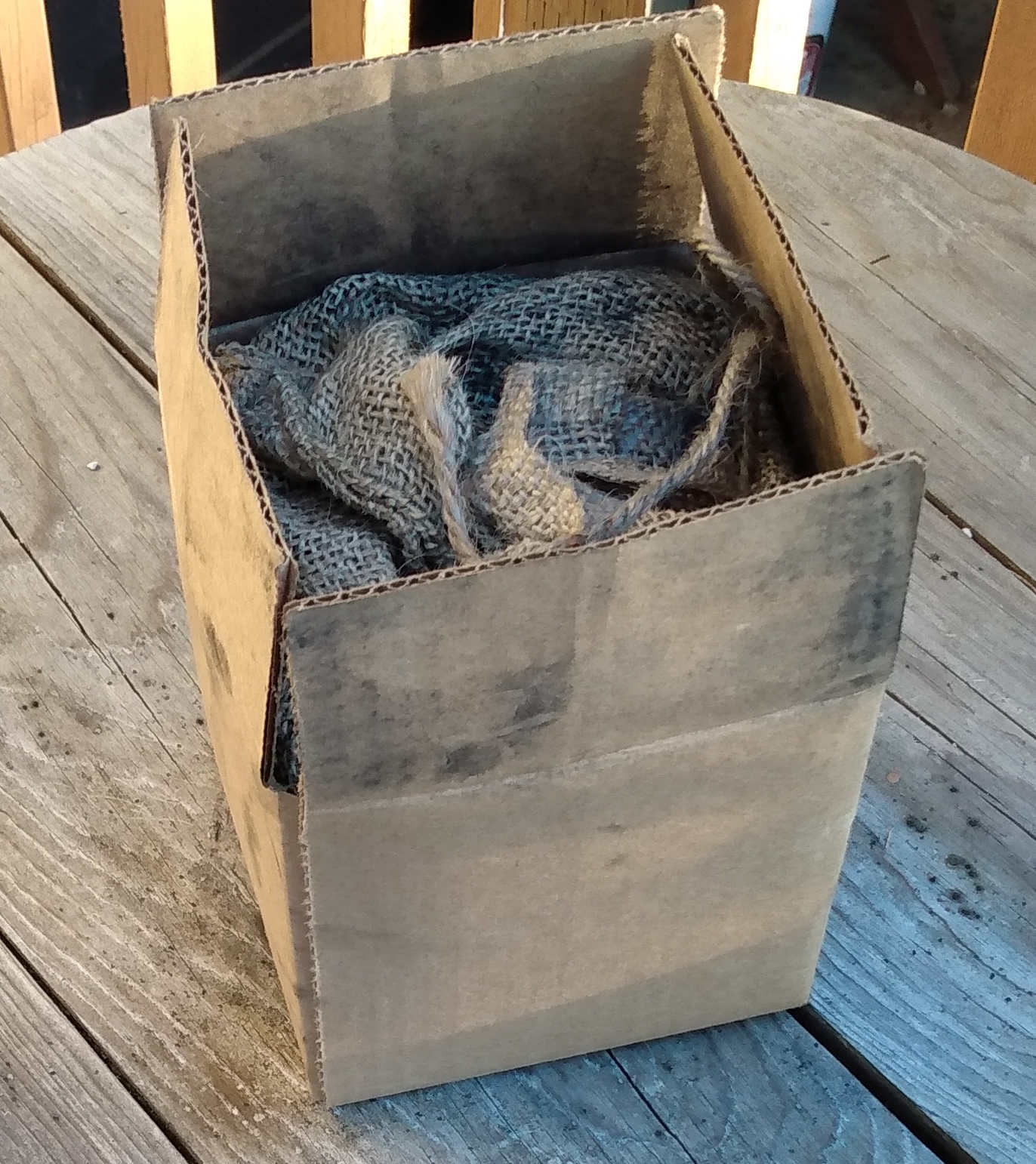 Biochar in box. Biochar is in a burlap sack that is placed in the box. 