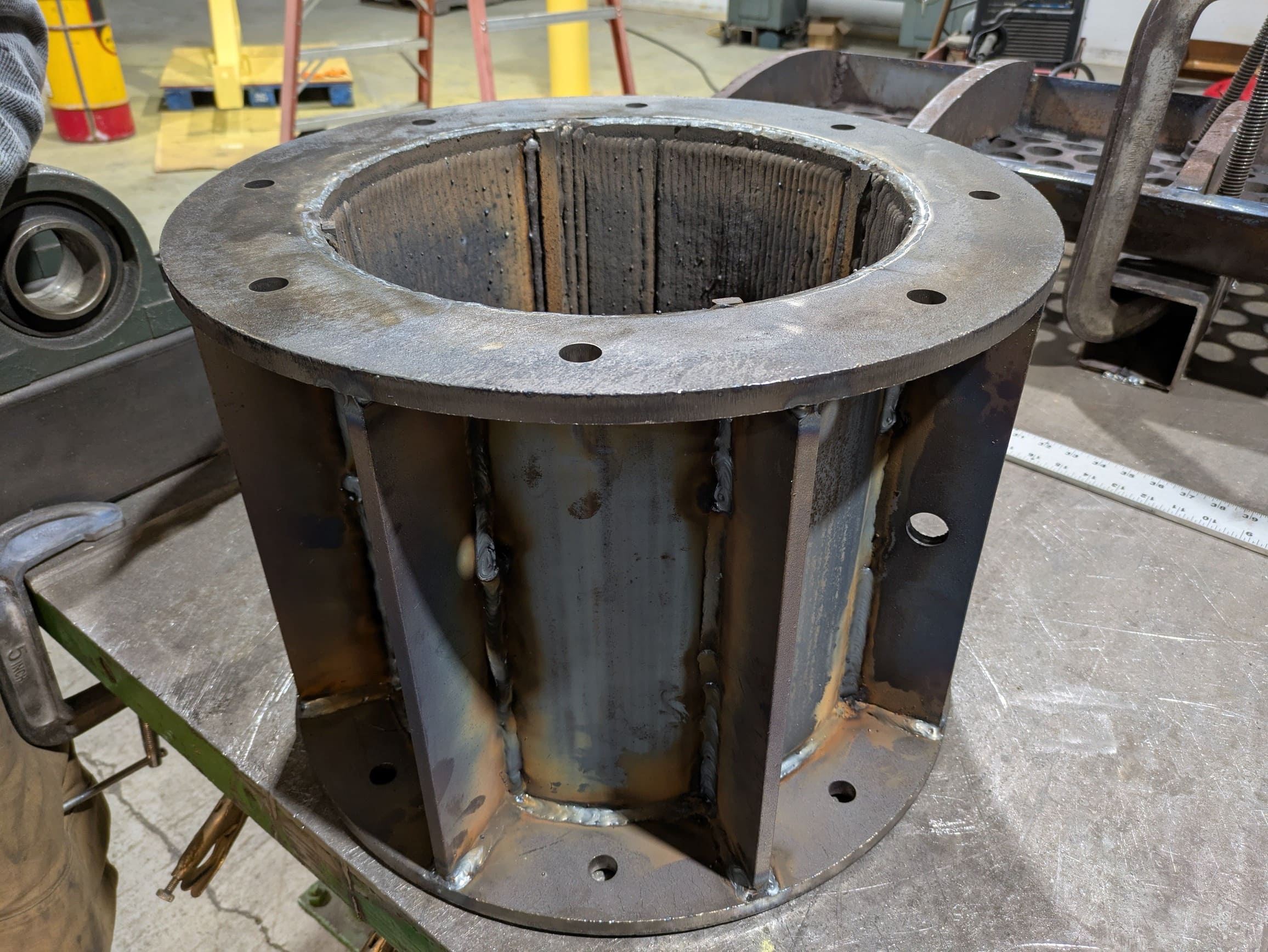 Steel compaction tube weldment for compressing plastic bottles.