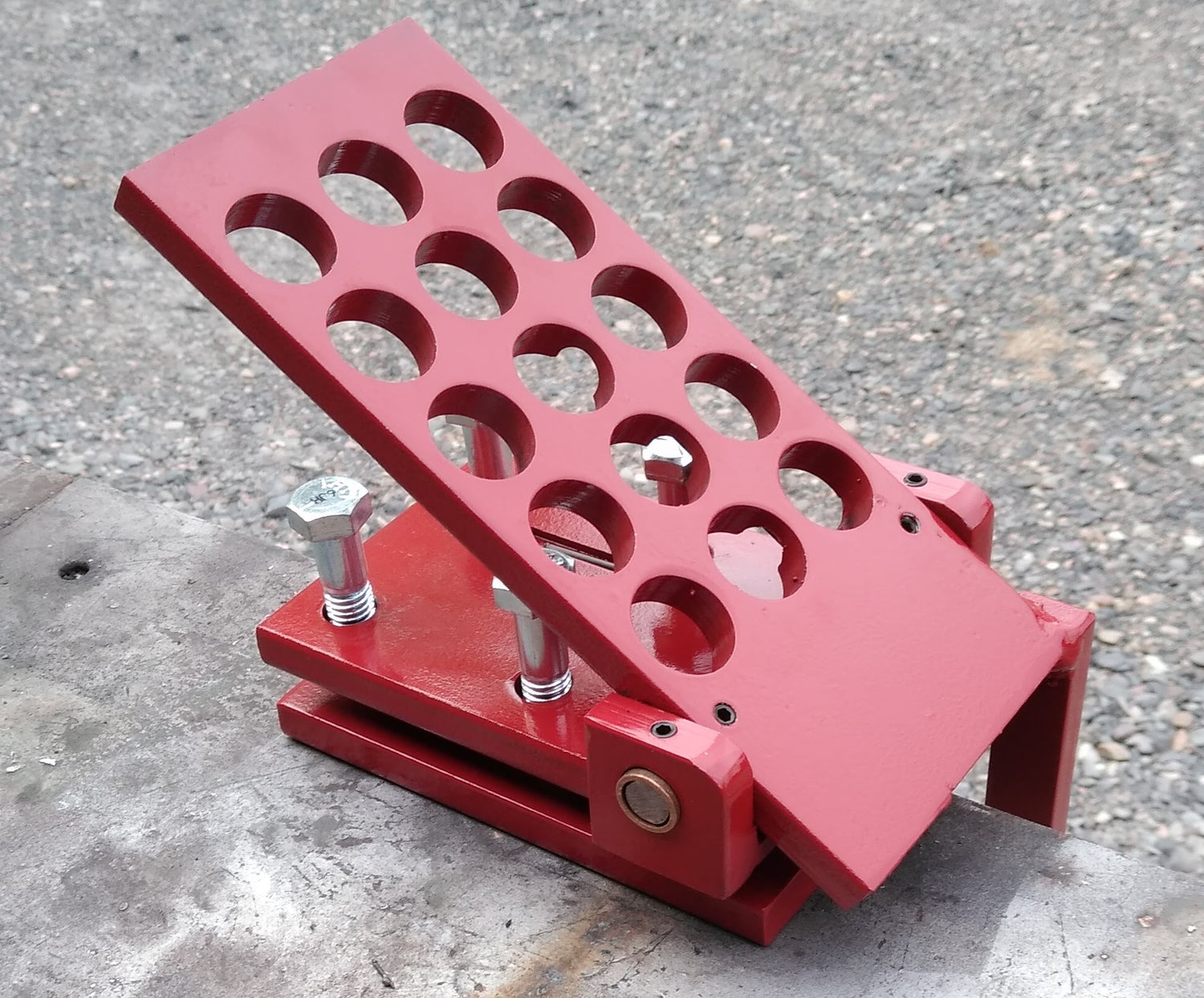 A custom steel foot pedal painted red.