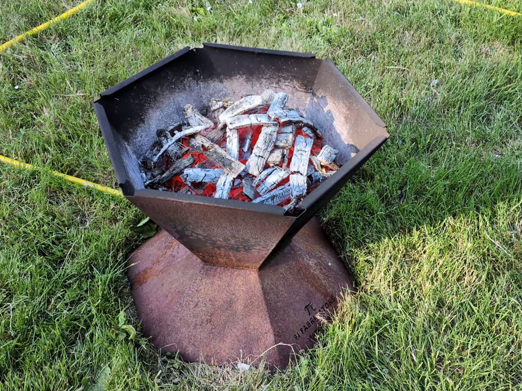 Glowing red charcoal with no flames left in the Biochar-Making Fire Pit, ready to quench