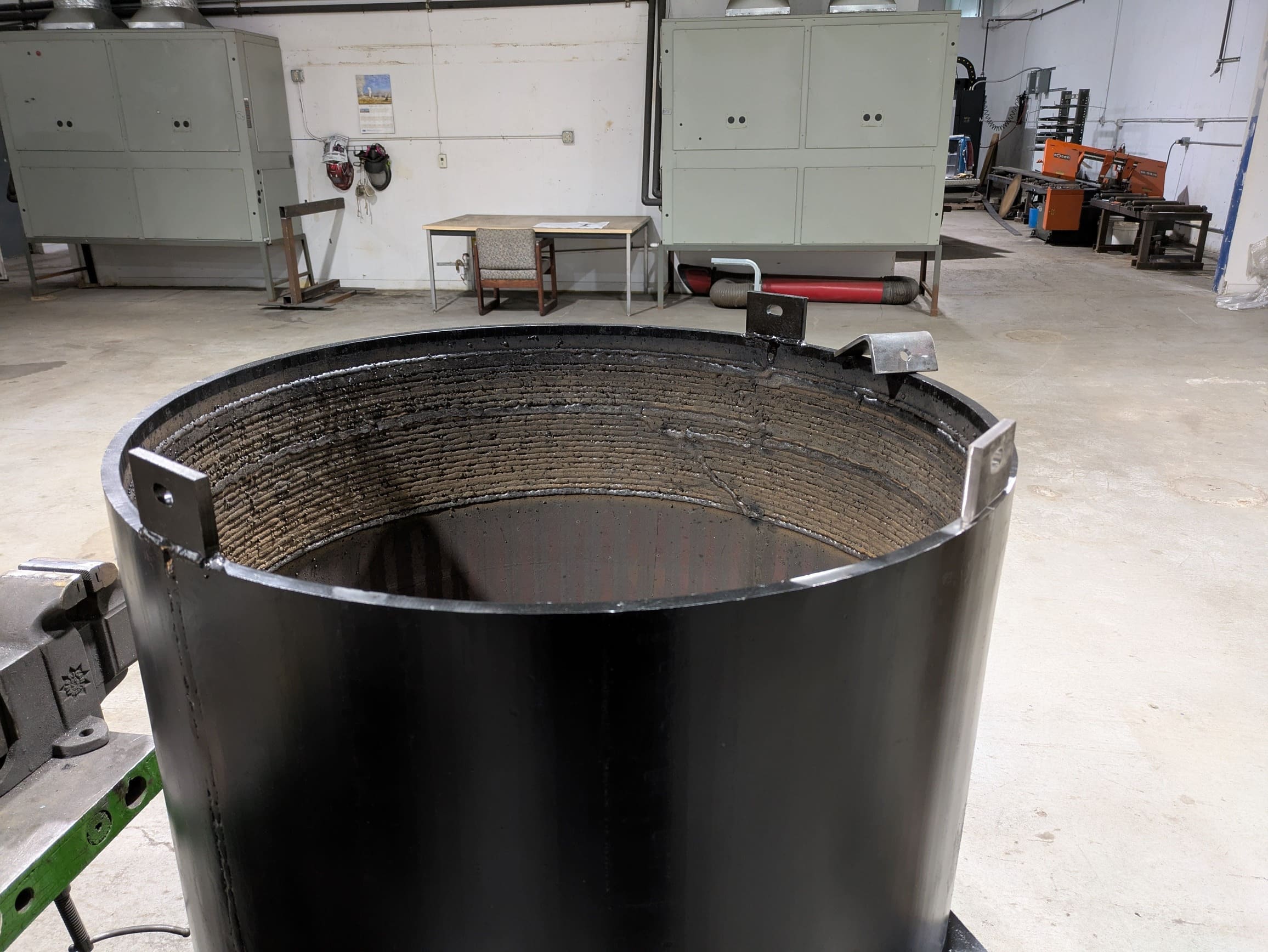 Glass breaker skirt for bottle crushing, showing internal hardface treatment to extend its wear life.