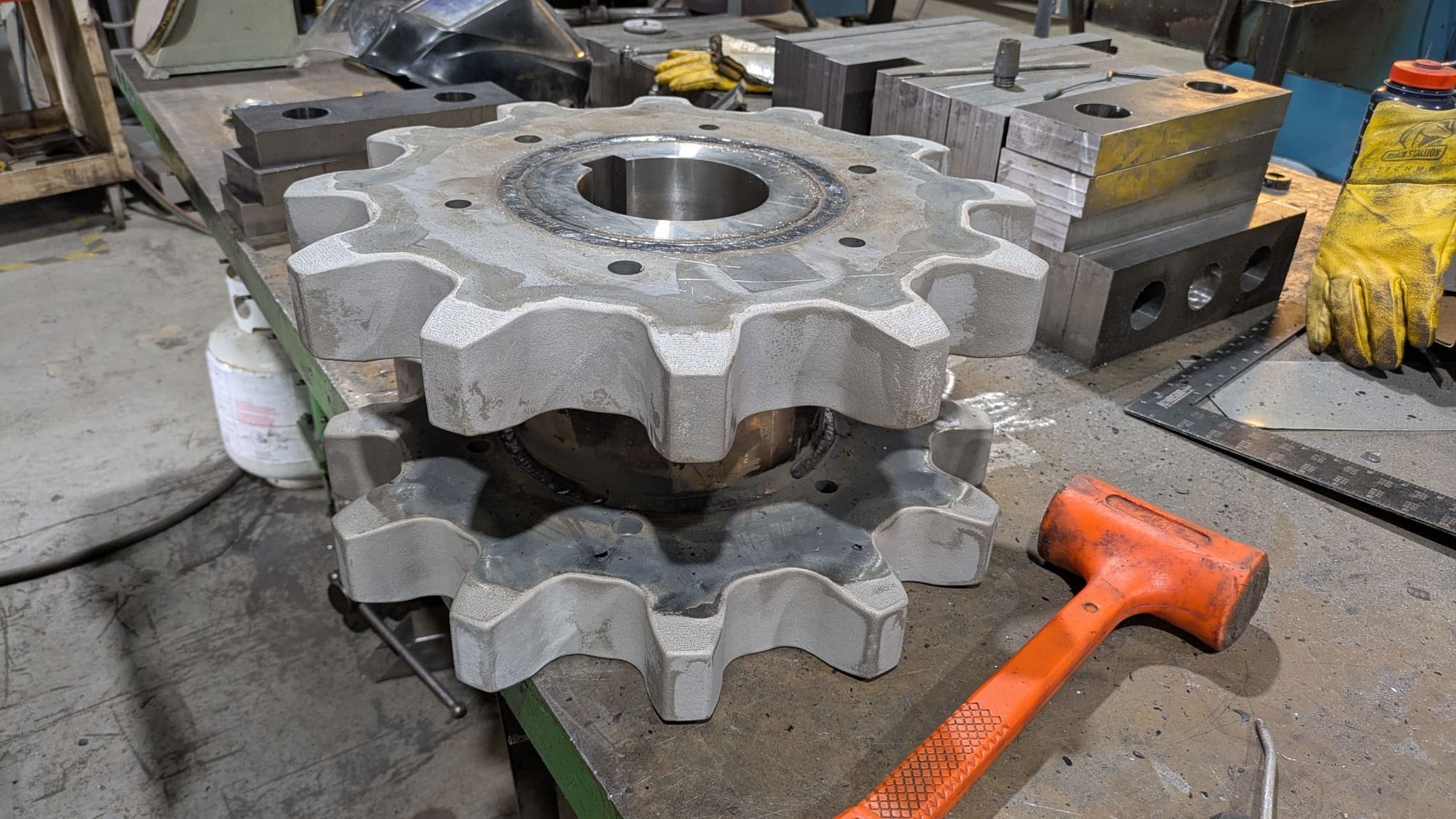 Hardfaced steel sprocket weldment for a conveyor chain in the wood products industry.