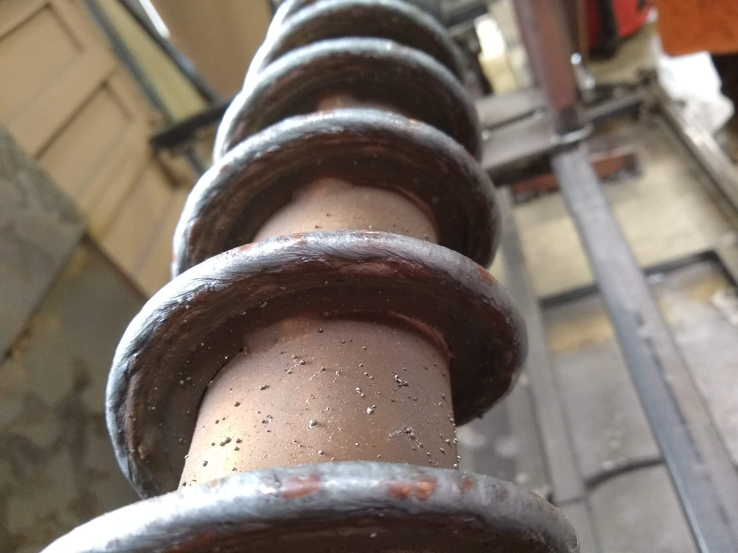 A close up image of an auger for perlite conveying that has had its surface rebuilt with weld overlay. 