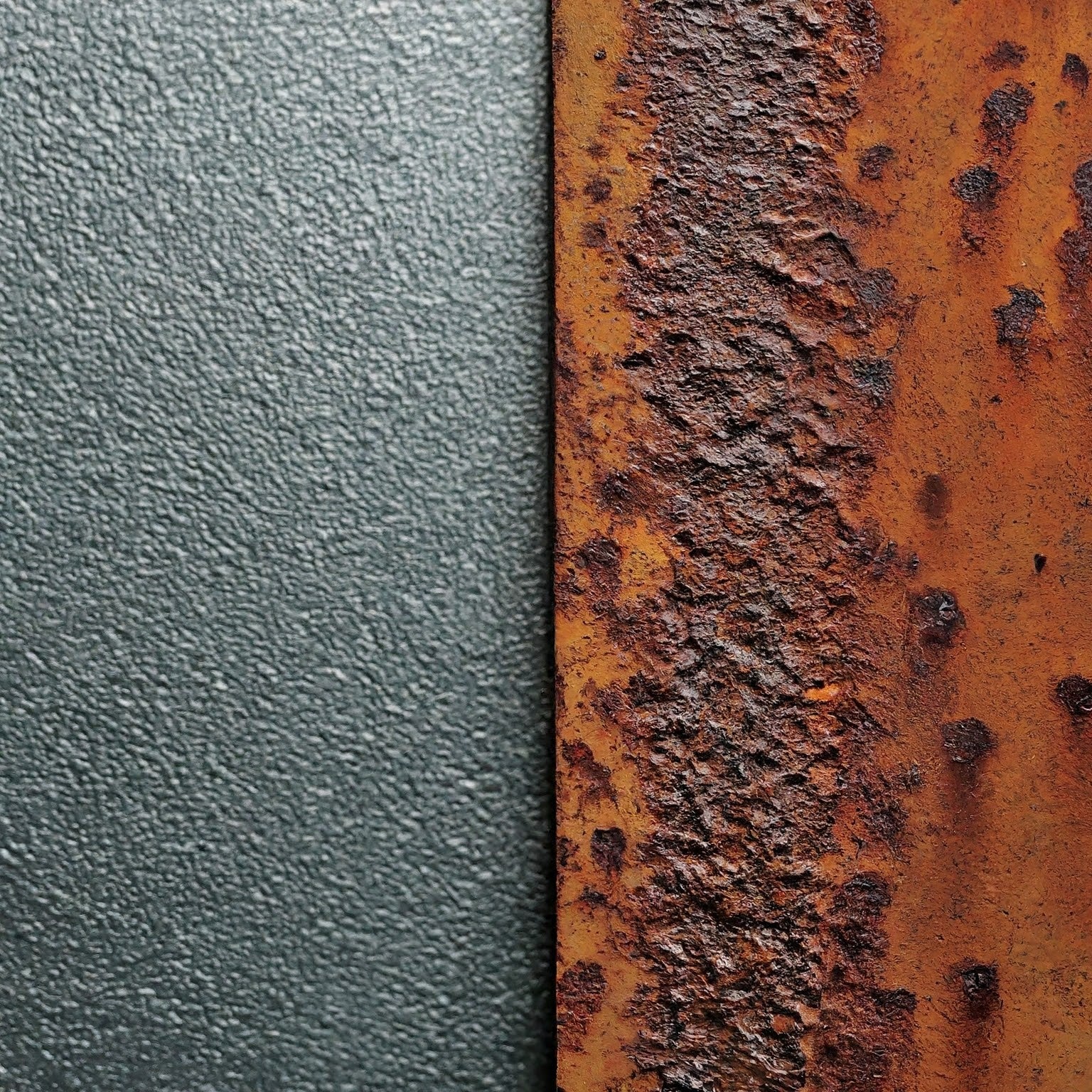 A rusty metal plate next to a clean abrasively blasted metal plate