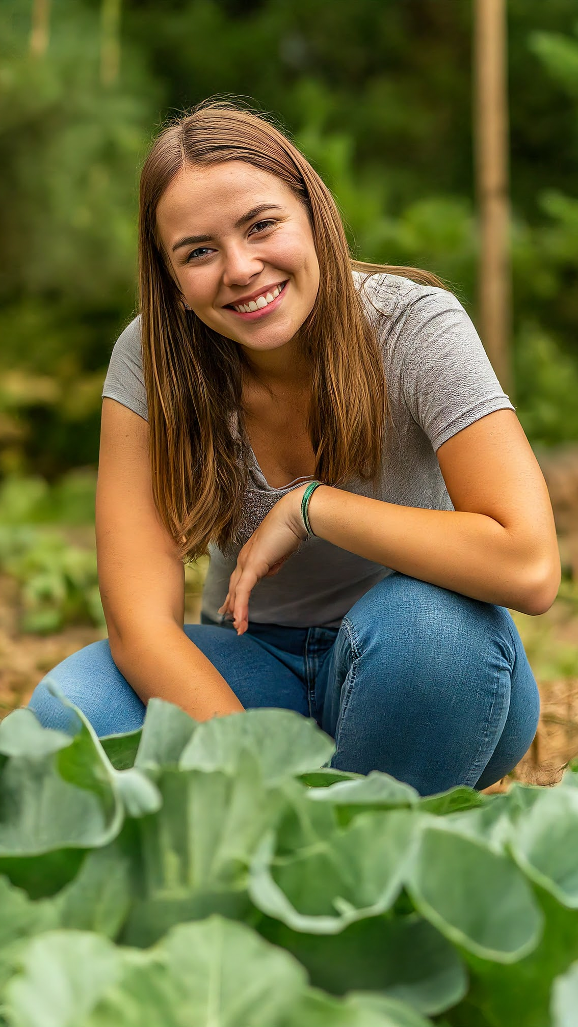 Smiling woman in vegetable garden.